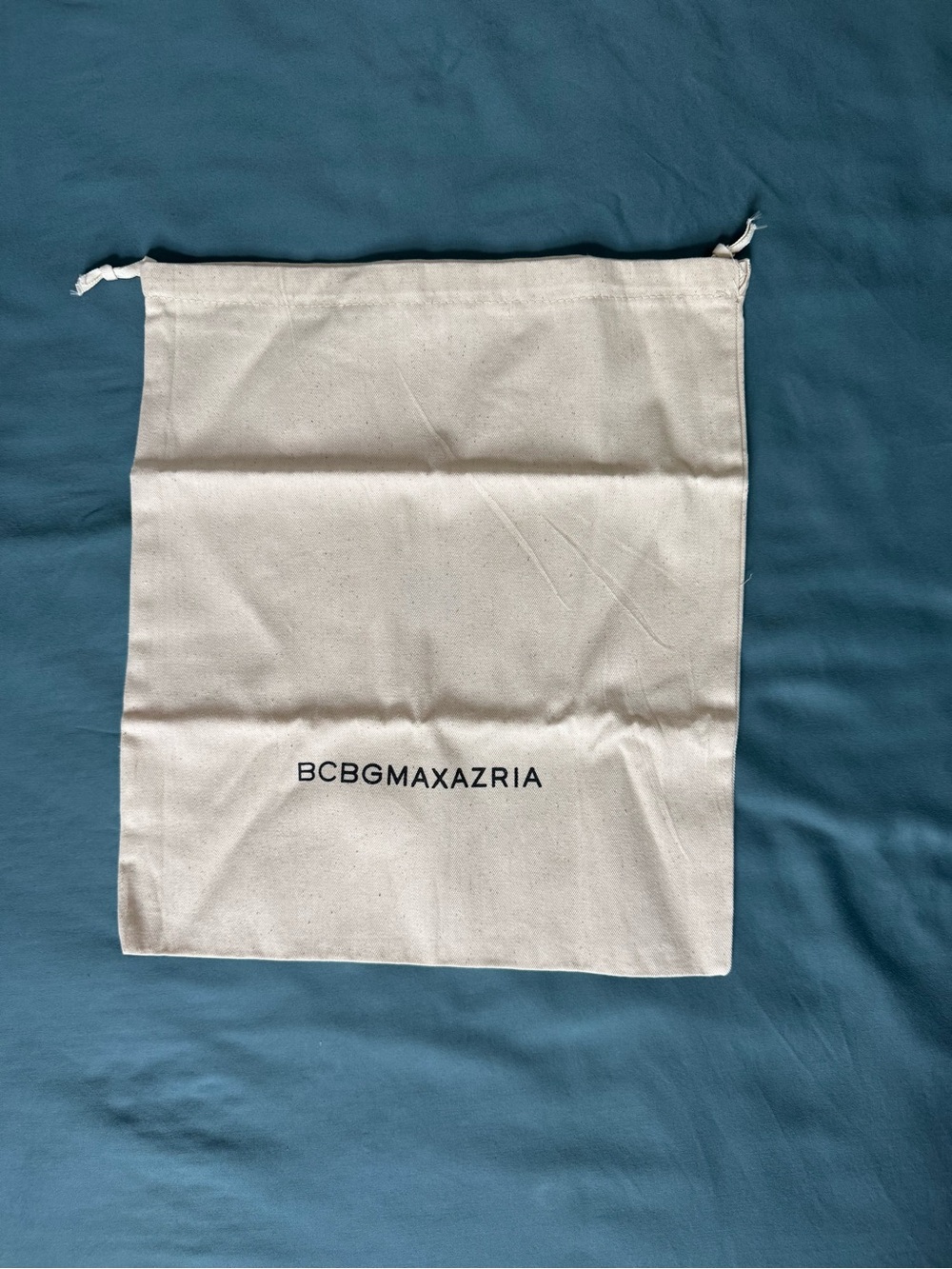 BCBGMaxAzria Cream Canvas Drawstring Bag with Black Logo